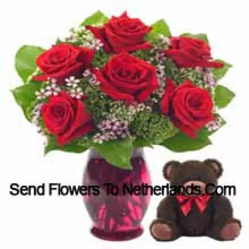 7 Red Roses With Some Ferns In A Glass Vase Along With A Cute 14 Inches Tall Teddy Bear