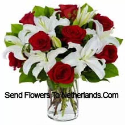 Red Roses And White Lilies With Seasonal Fillers In A Glass Vase