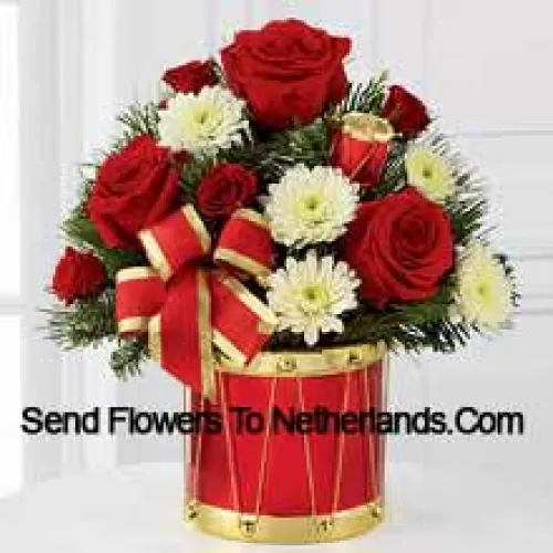 A blossoming display of seasonal merriment and festive greetings. Rich red roses and spray roses sweetly mingle with white chrysanthemums arranged amongst lush holiday greens, all perfectly accented with drum pics and a gold-edged red ribbon. Arriving in a designer red and gold drum inspired vase, this bouquet will express your most heartfelt wishes for a wonderful holiday season. (Please Note That We Reserve The Right To Substitute Any Product With A Suitable Product Of Equal Value In Case Of Non-Availability Of A Certain Product)